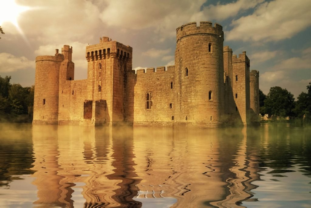 brown concrete palace surrounded by body of water during daytime