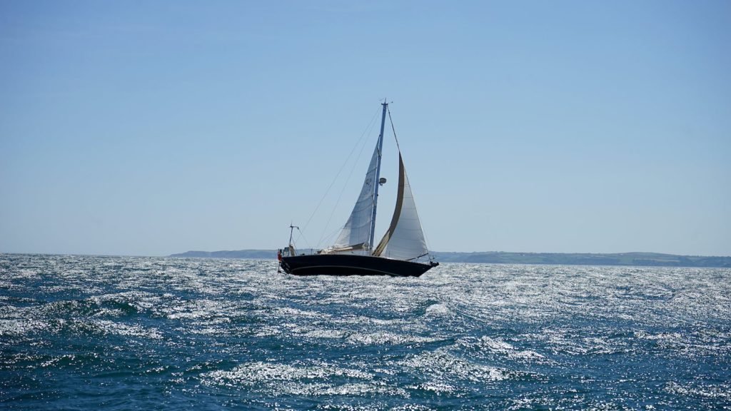 White and Black Sail Boat on Ocean