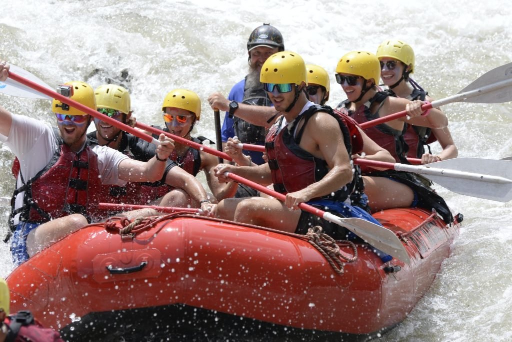 a group of people riding on top of a raft